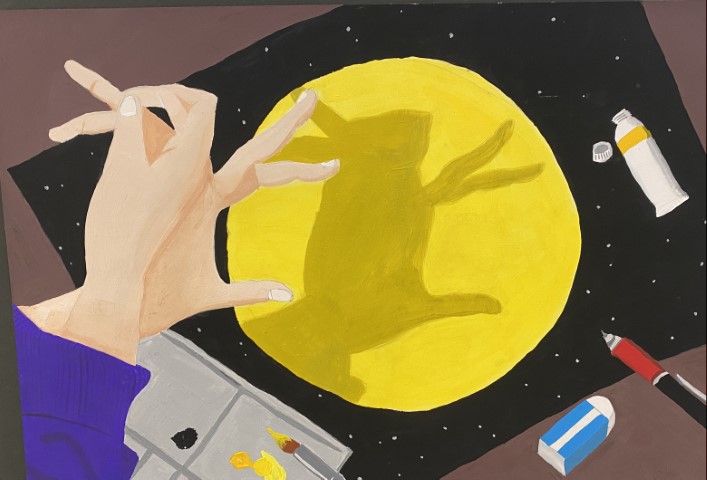 Student artwork of a person creating an artwork of the moon with paint, a paintbrush, pencil and eraser in the background. The artist is making a shape with their hands to cast a shadow of a rabbit on their painting of a bright yellow moon with black background.