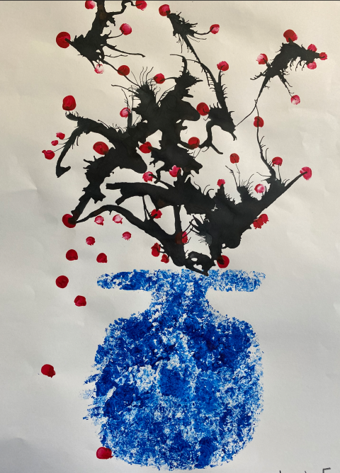 student artwork of a blue vase with red cherry blossoms in the vase with black stems.  