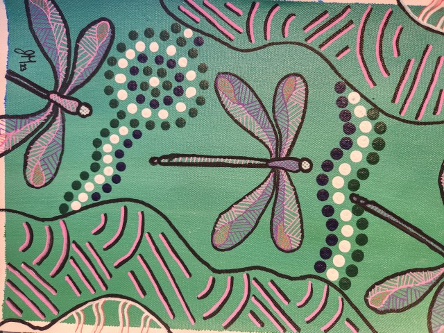 A painting of dragonflies on a green background.