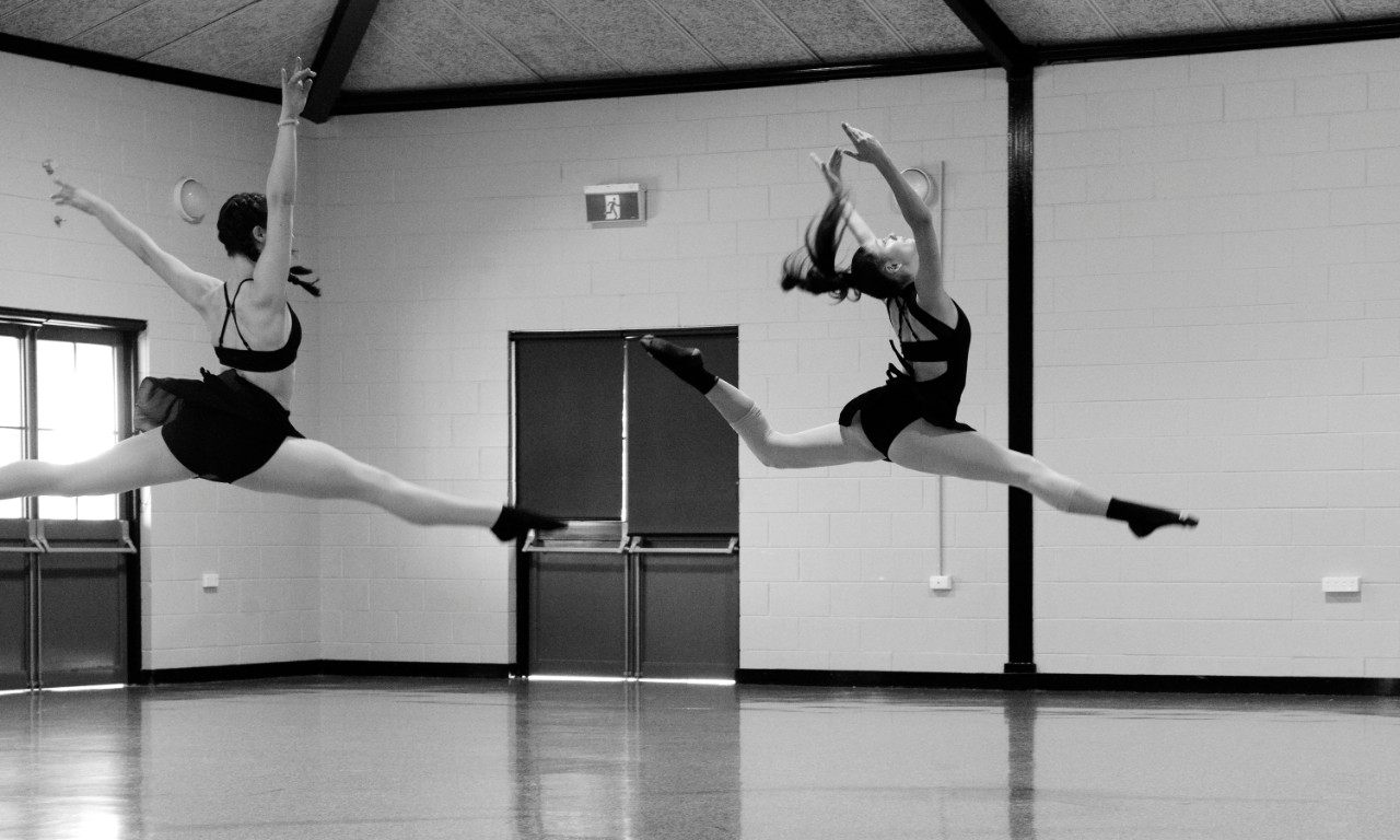 Two dancers leaping (jete)
