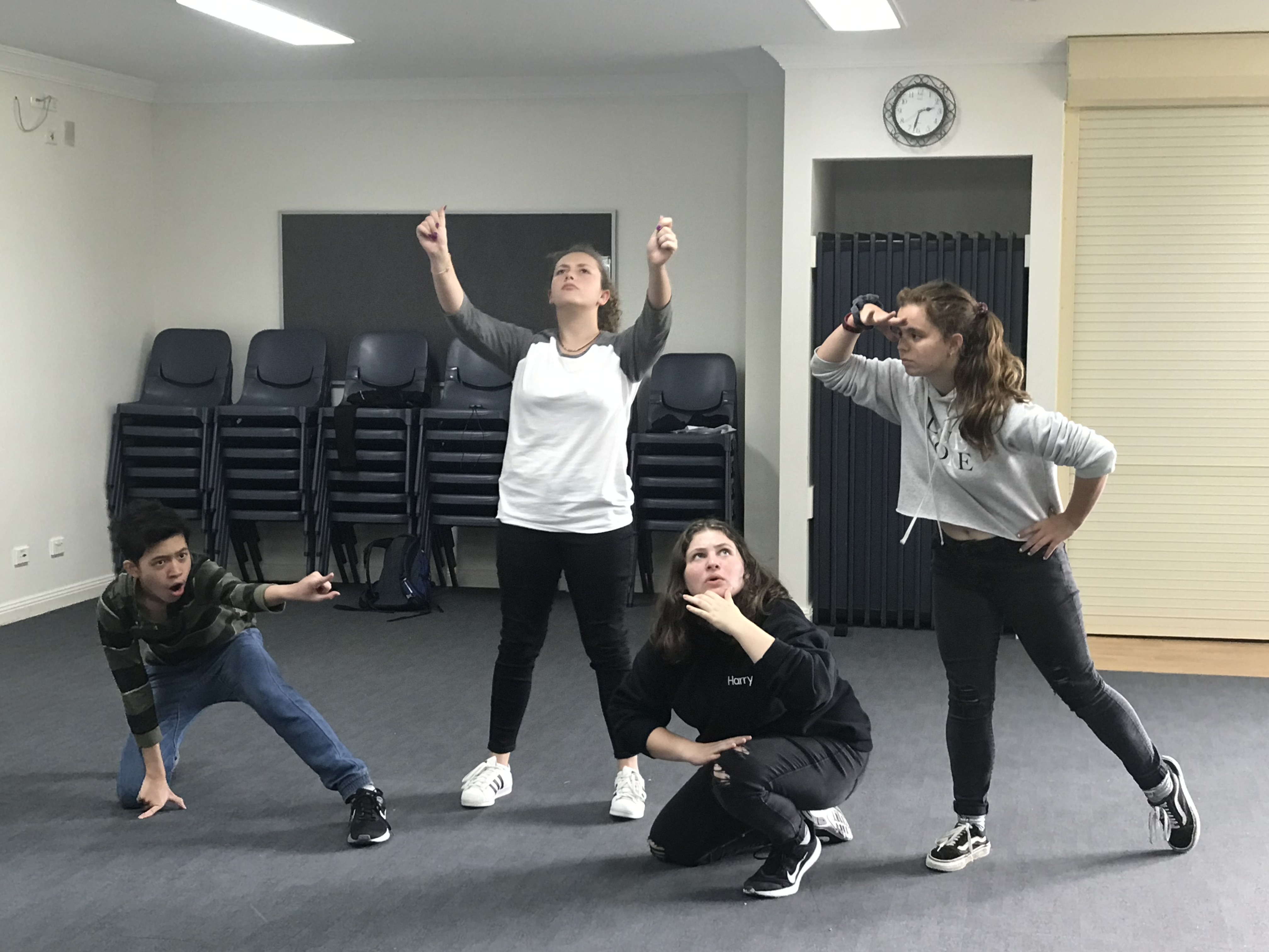 4 students acting out a scene in a performance space