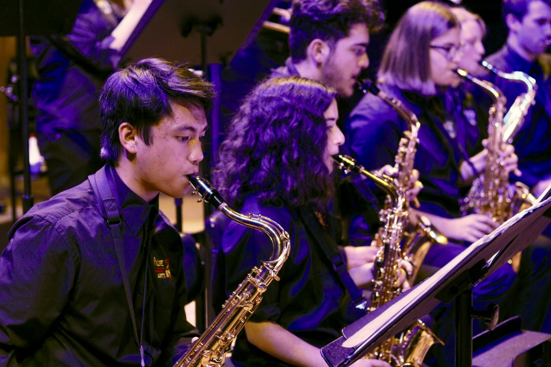 group of students playing saxaphone on stage