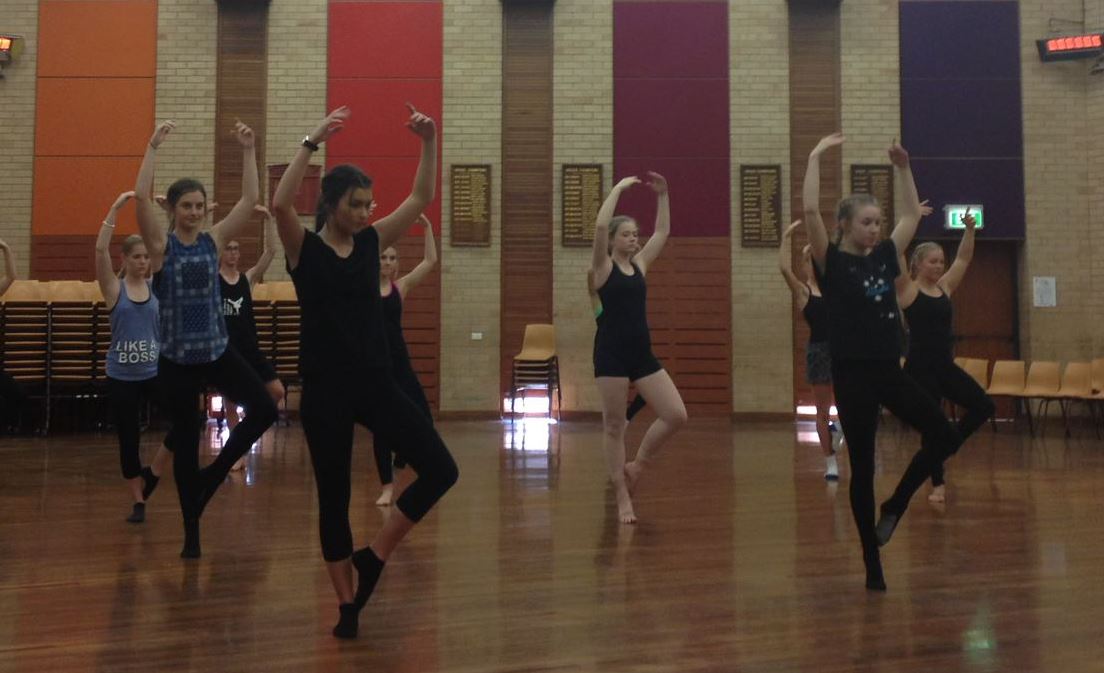 group of dancers preparing for a pirouette turn 