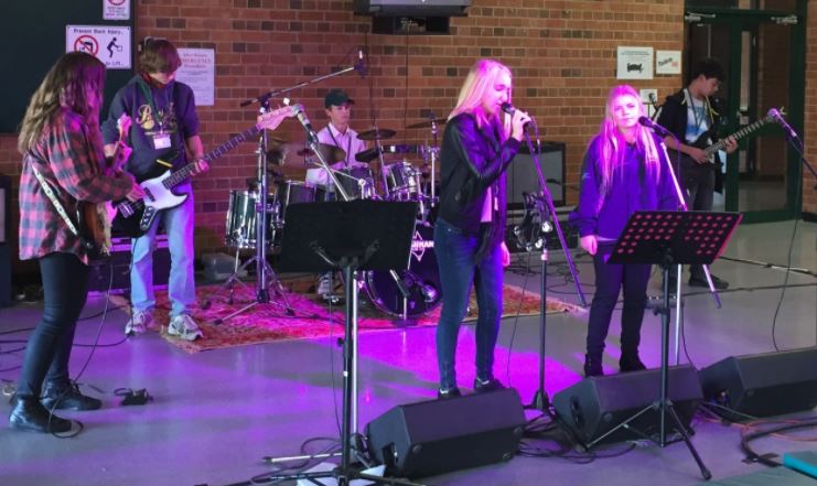 small school rock band performing in school space