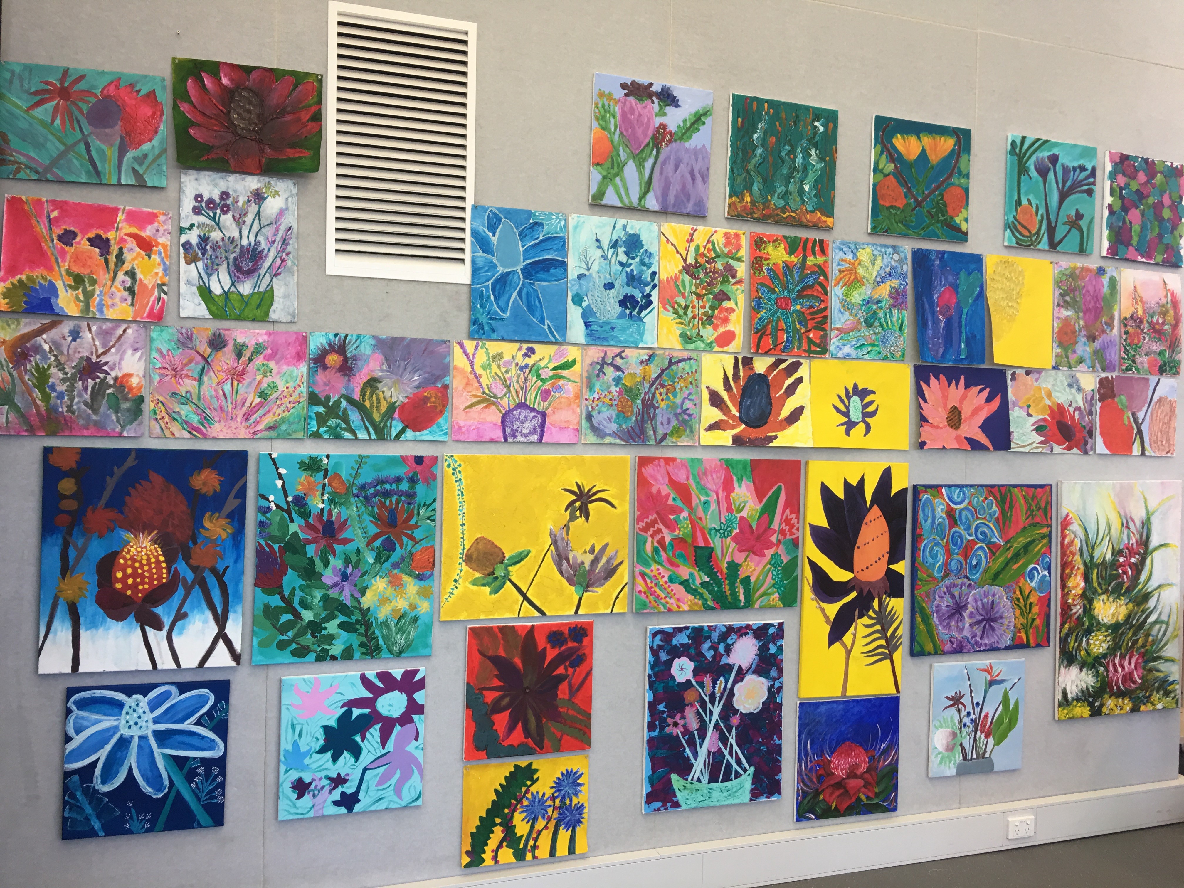 Student artworks on display on a wall