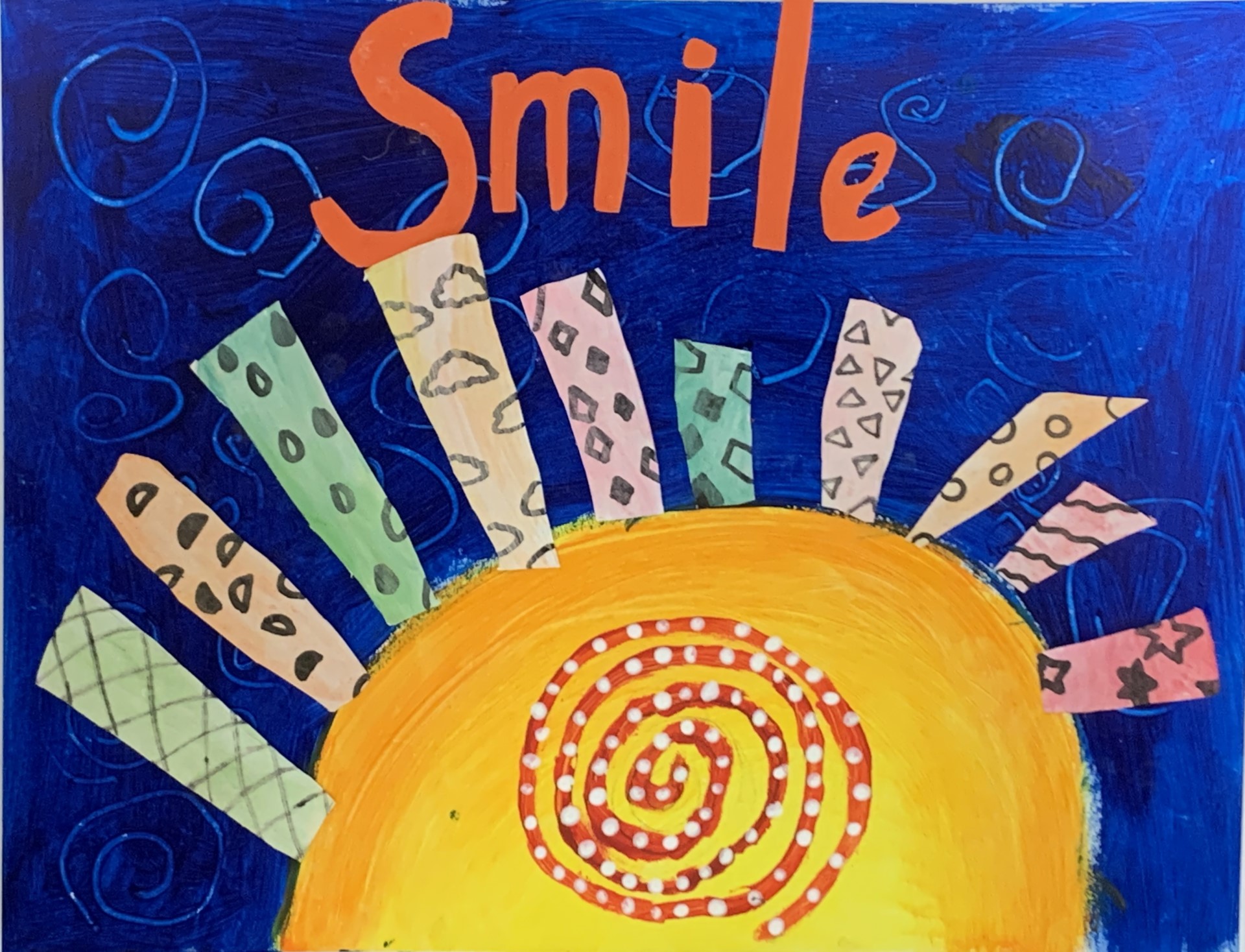 student artwork of the sun on a blue background with the word Smile above it.  The rays of the sun are a range of patterns