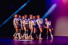 Riverina Albury Junior Ensemble in a group formation leaning back and wearing futuristic costumes