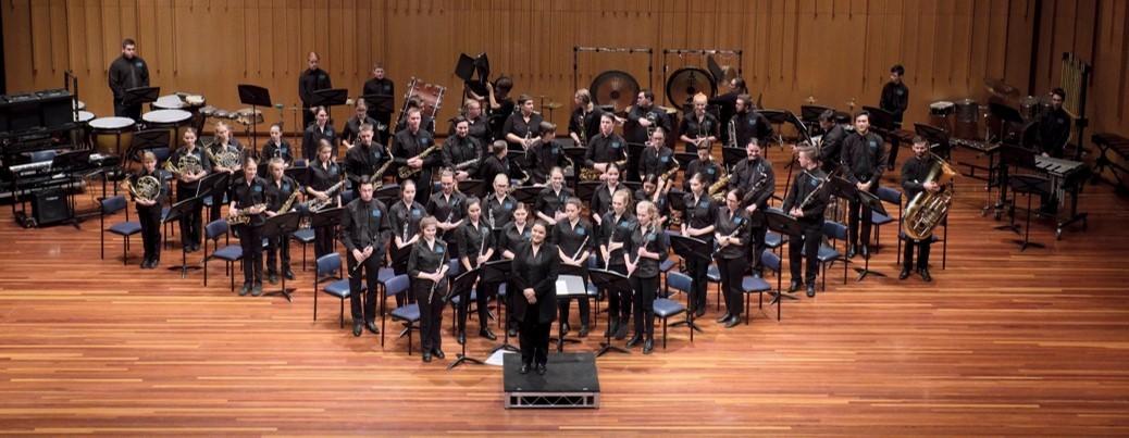 The Hunter Wind Ensemble performing in a concert hall.