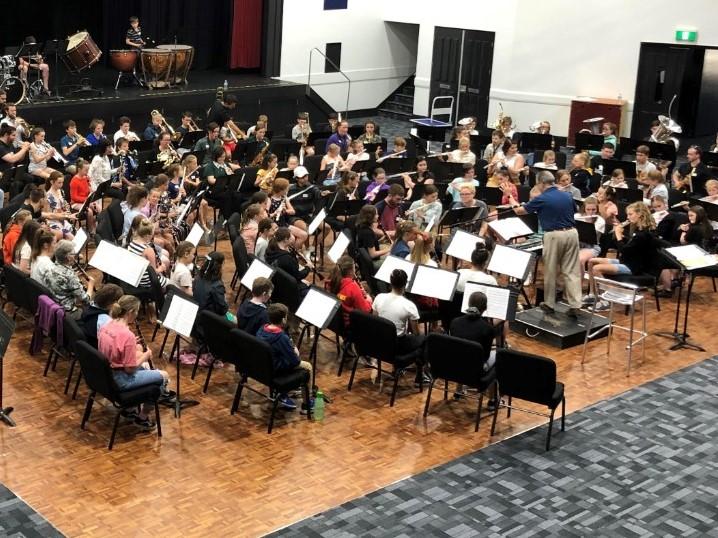 concert band in rehearsal at venue.