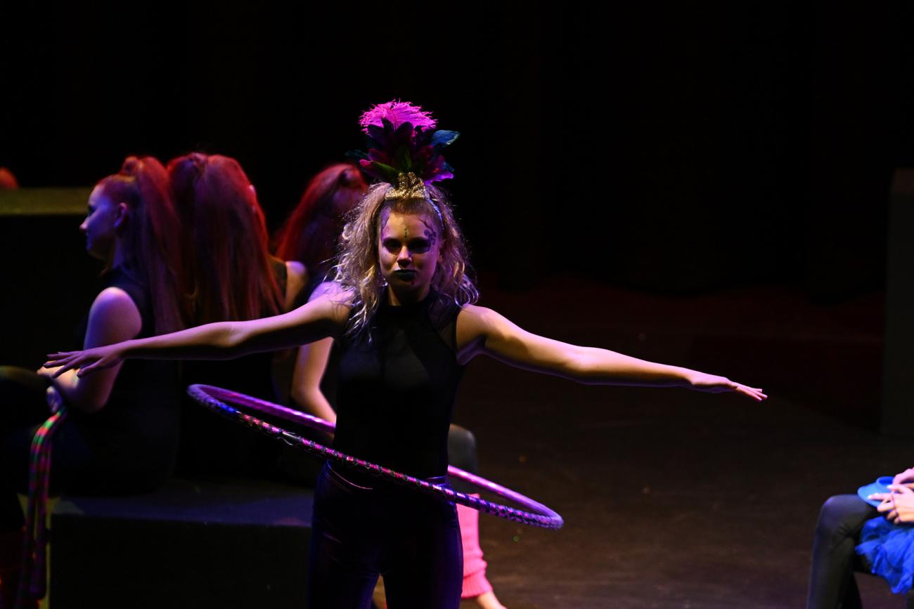Student on stage with hoop around waist