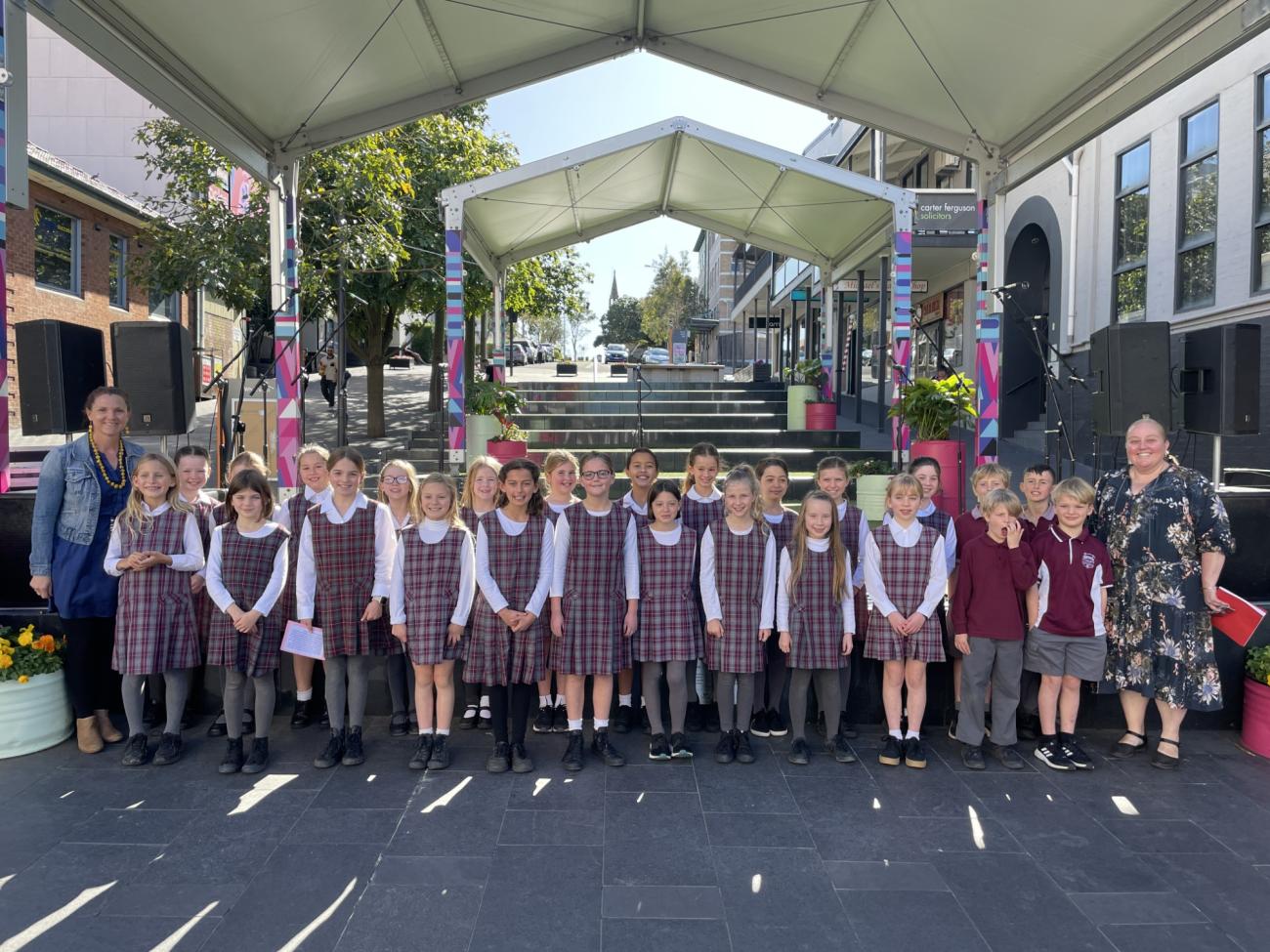 Austinmer Public School Choir standing in front of the stage in school uniform for photo