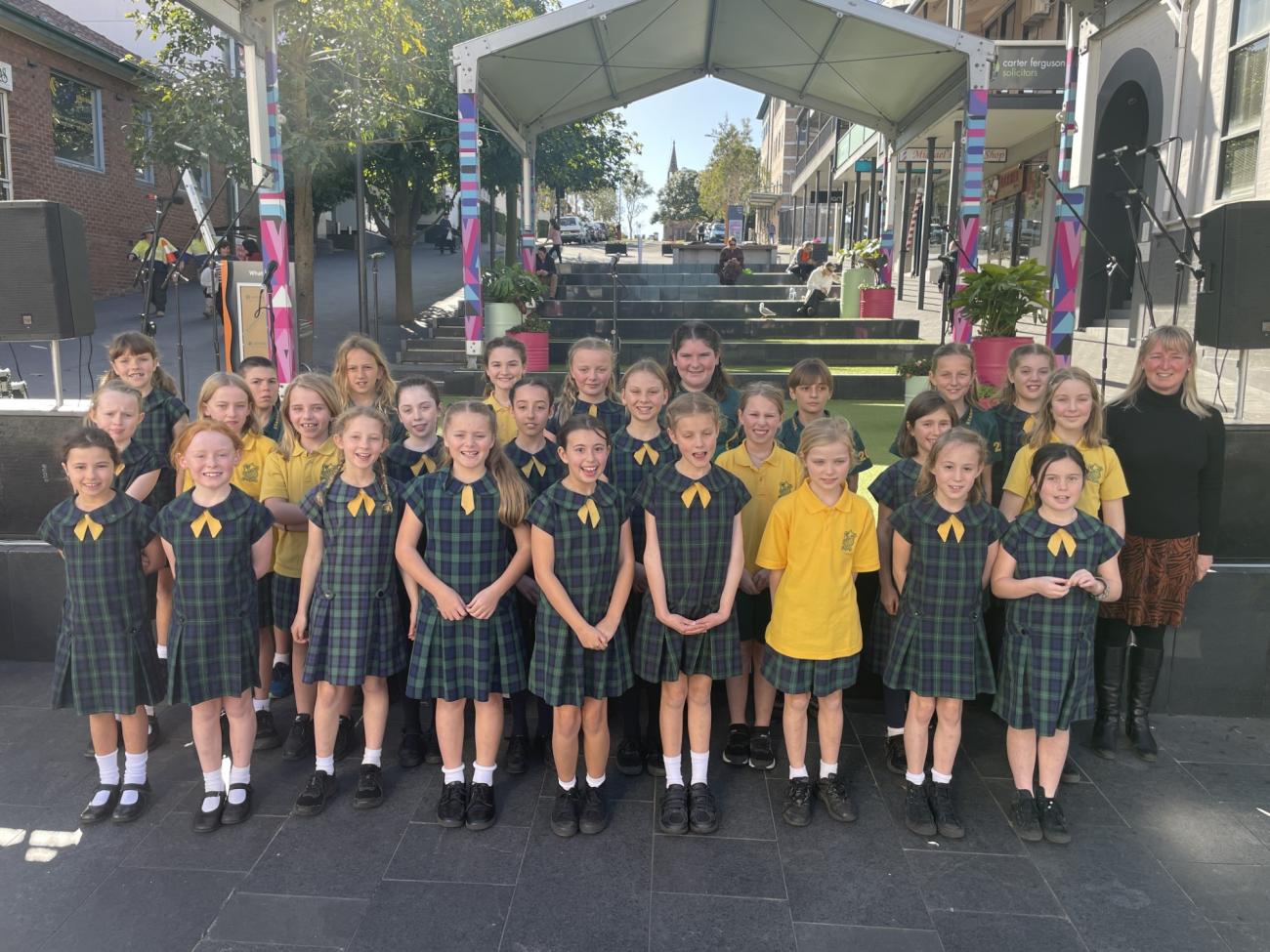 Stanwell Park Public School Choir standing in front of the stage in school uniform for photo