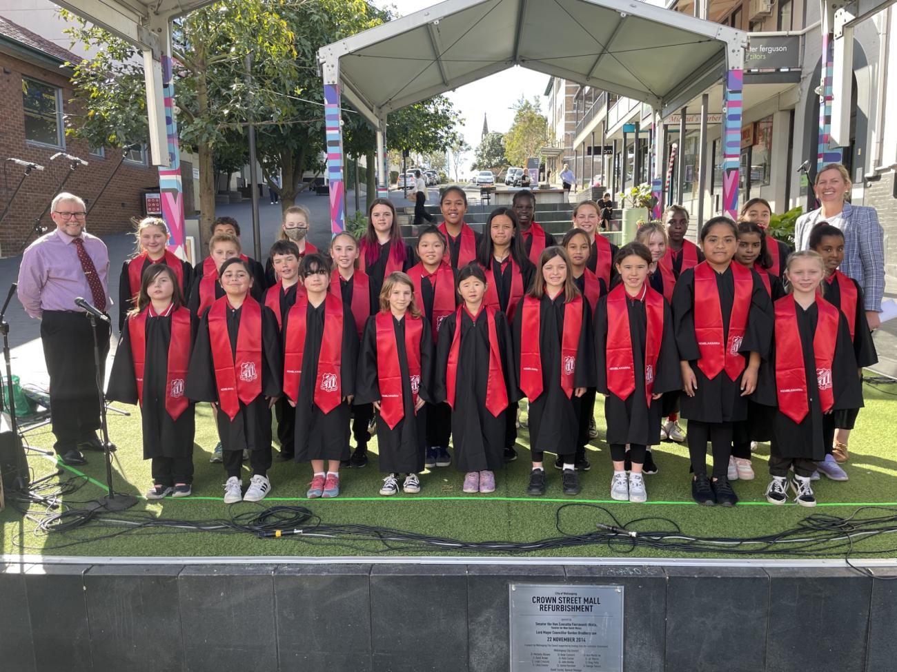 Kemblawarra Public School Choir standing in front of the stage in school uniform for photo