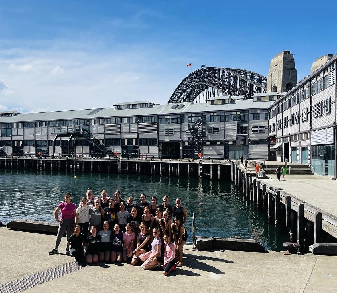 Dancers posing for a photo in front of the Sydney Harbour Bridge