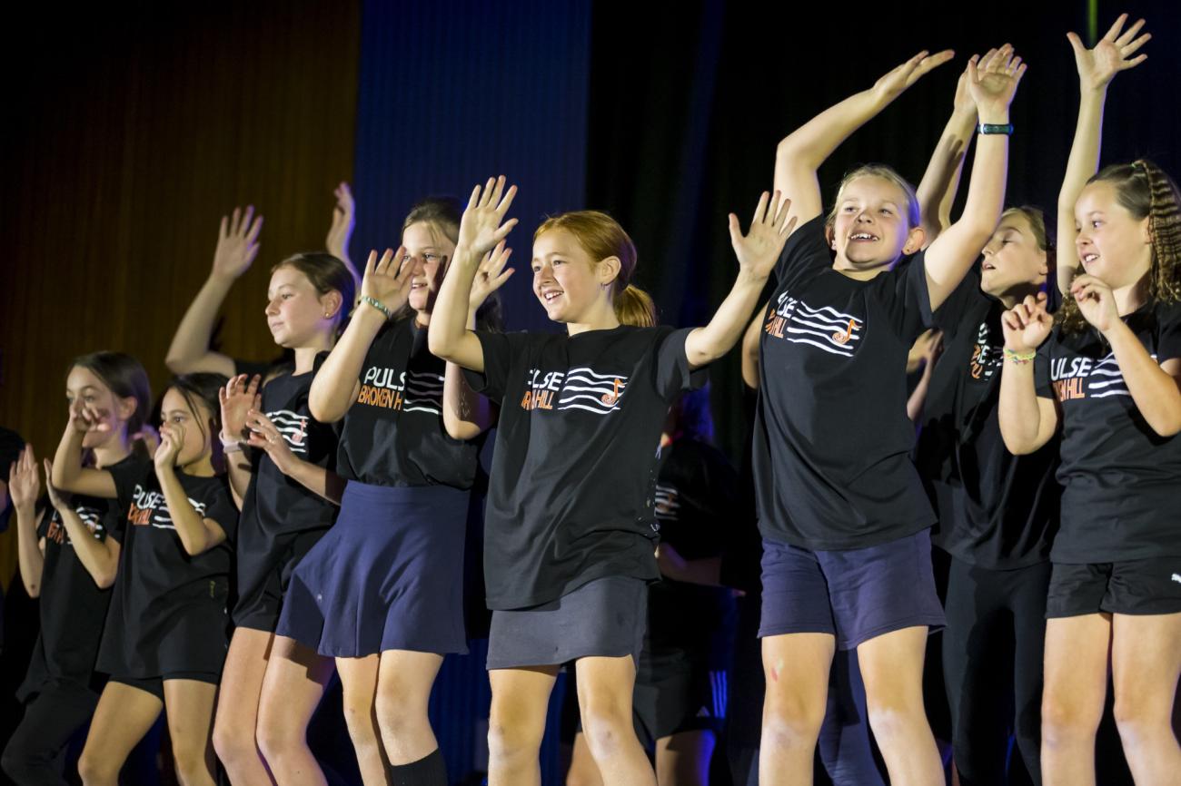 Dancers expressing joy while performing on stage