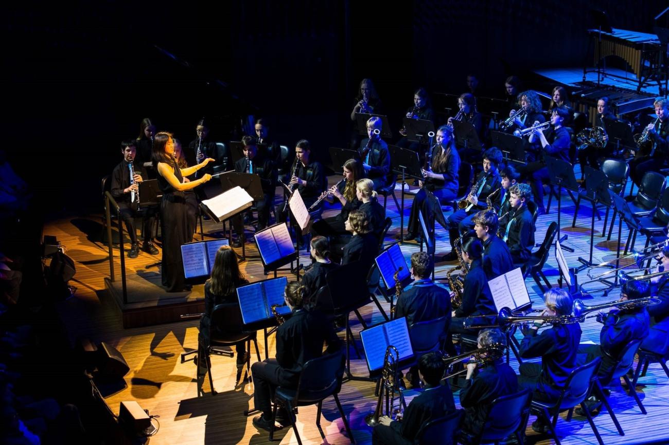 SNPS Symphonic Band performs onstage at the Sydney Opera House
