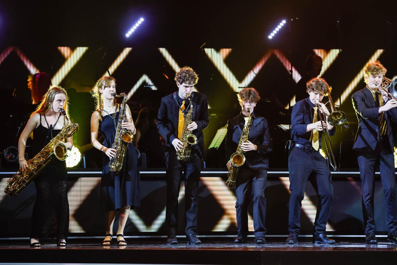 A line of musicians playing brass instruments