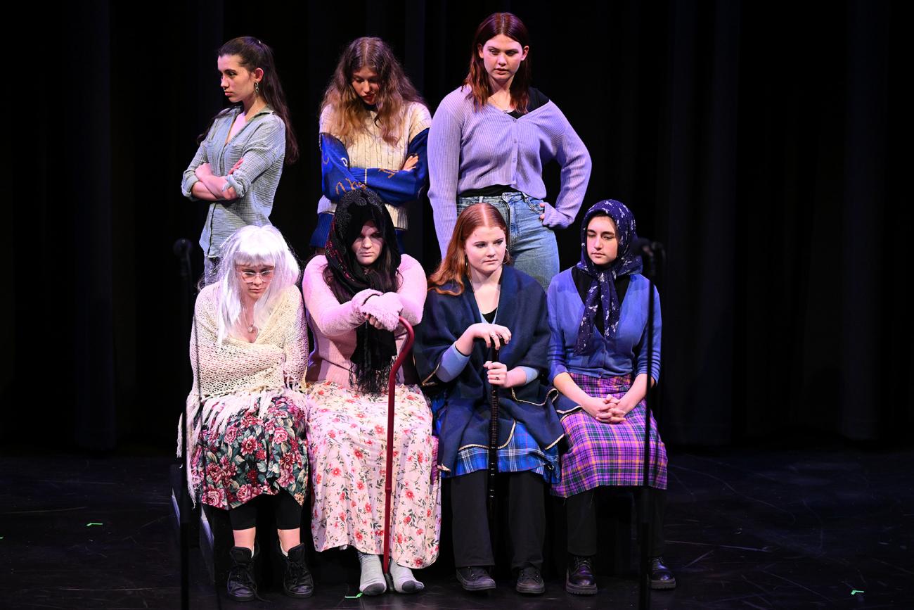 7 students on stage dressed to depict older women 