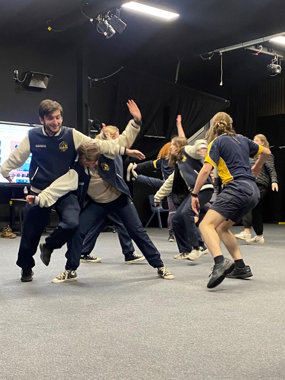 Senior students engaging in a pyhsical drama activity and moving around each other