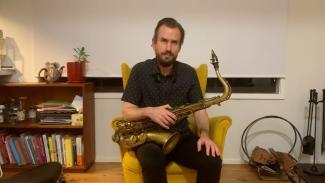James Loughnan holding a saxophone