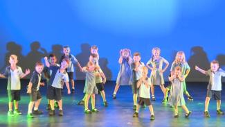 Young drama students performing the play Day One in the State Dance Festval