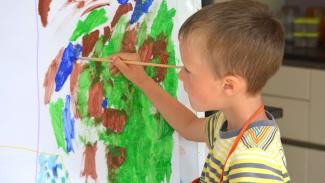 A young boy painting