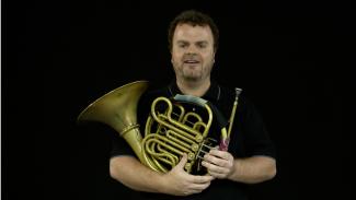 Michael Wray holding a french horn