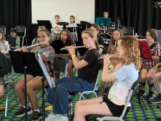 Children playing musical instruments in the camp concert band