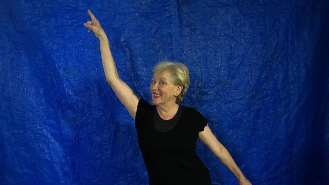 Teacher Virginia Ferris in a disco pose, with right arm pointing up