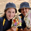 2 student holding their artworks made from paper